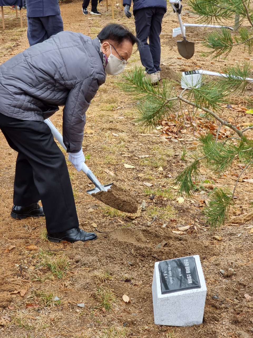 남영동 대공분실의 고문피해생존자 유동우 씨가 기념식수에 흙을 뿌리고 있다